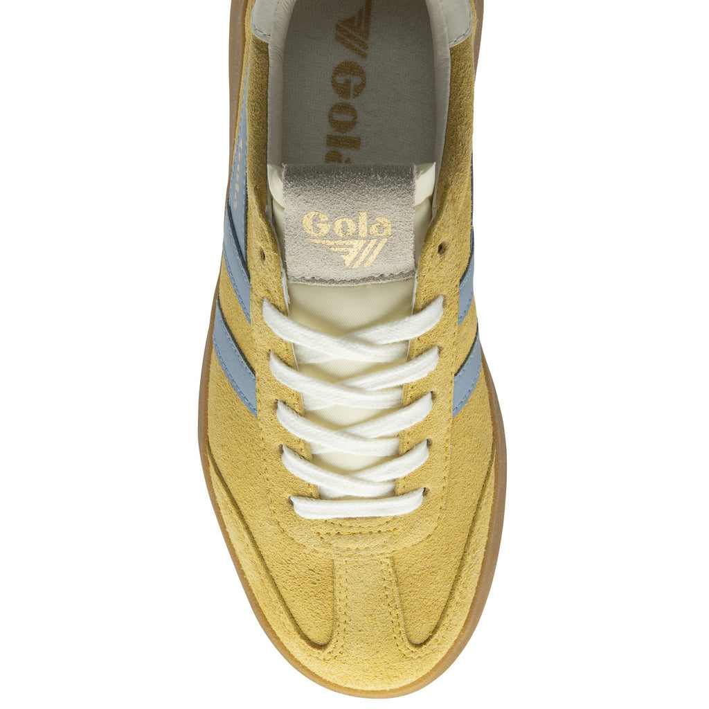 The top-down view of a mustard yellow Gola sneaker with light blue stripes.