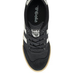 The top-down view of a black Gola trainer with white stripes and gum soles.