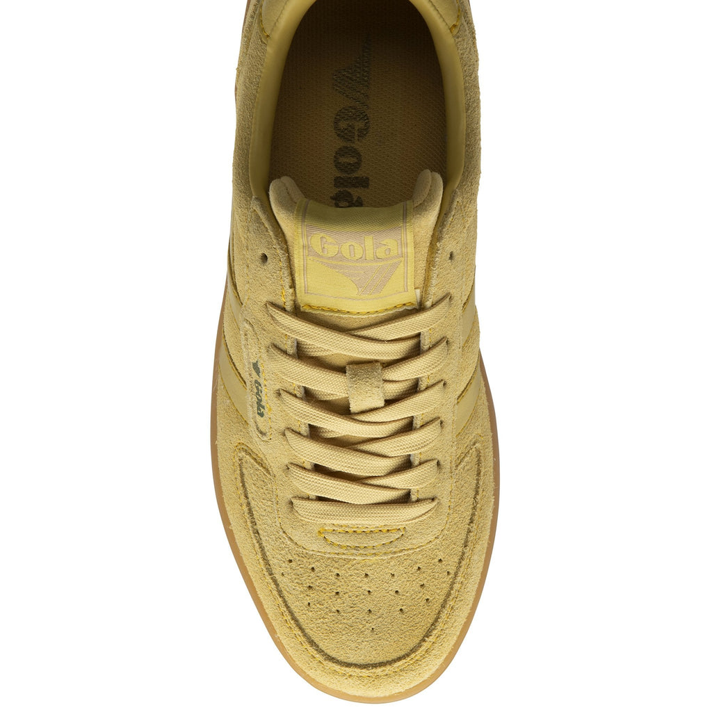 Top-down view of a single pale yellow Gola low-top suede sneaker with a brown rubber sole.