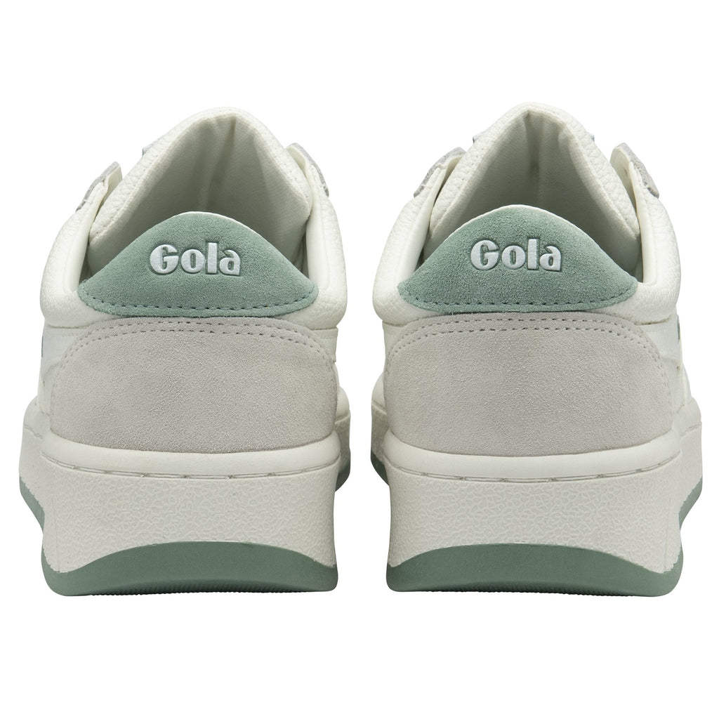 The back of a pair of white Gola sneakers, showing the green heel with the Gola logo.