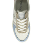 An overhead view of a white Gola sneaker with blue and beige details.
