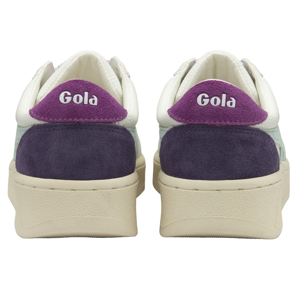 The back view of a pair of white Gola sneakers with purple accents and logo.