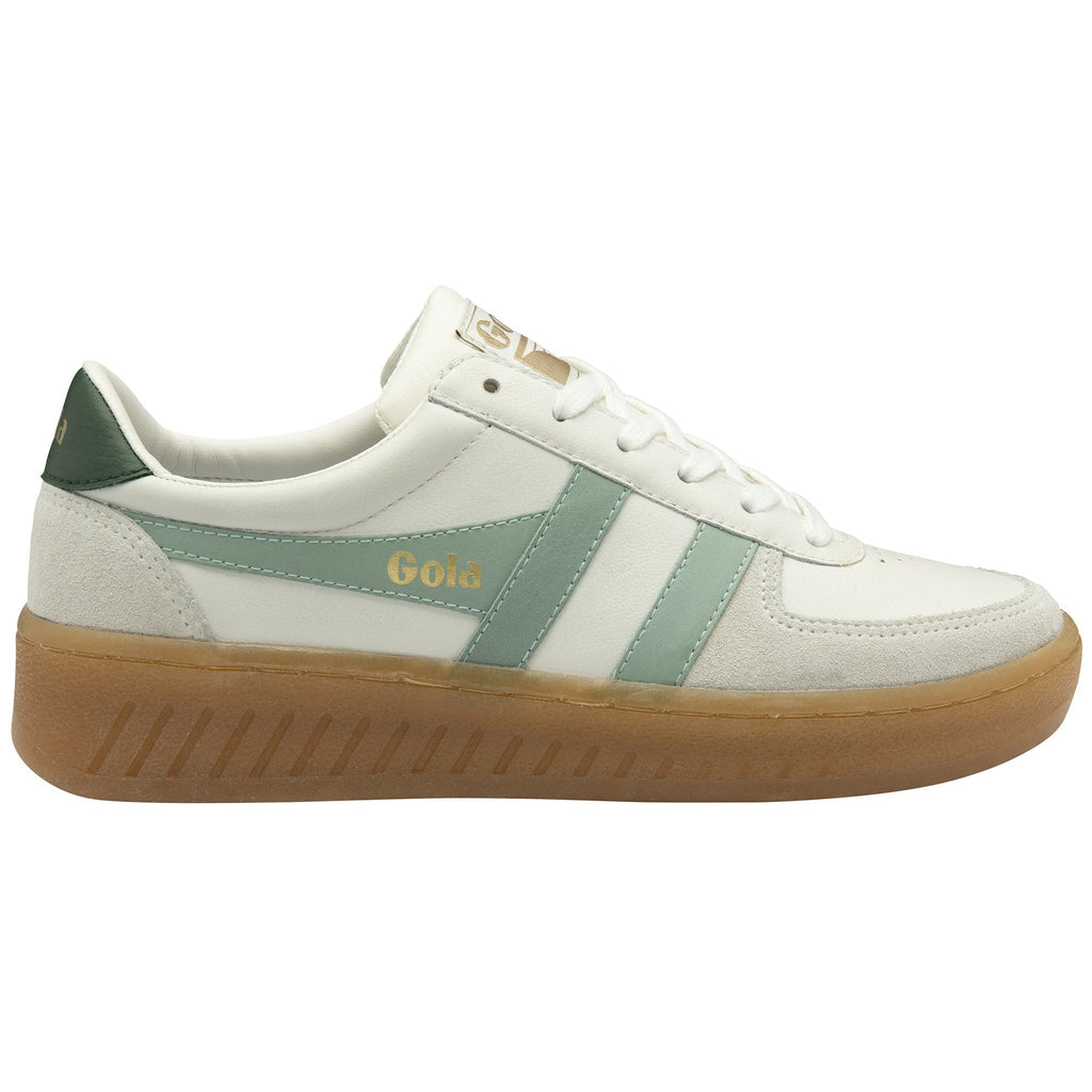 A white Gola sneaker with green stripes and a brown sole.