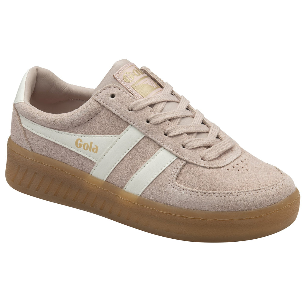 A pale pink suede Gola sneaker with white stripes and a gum sole, viewed from an angle.