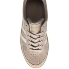 The top-down view of a single pale pink Gola sneaker with white stripes and a gum sole.