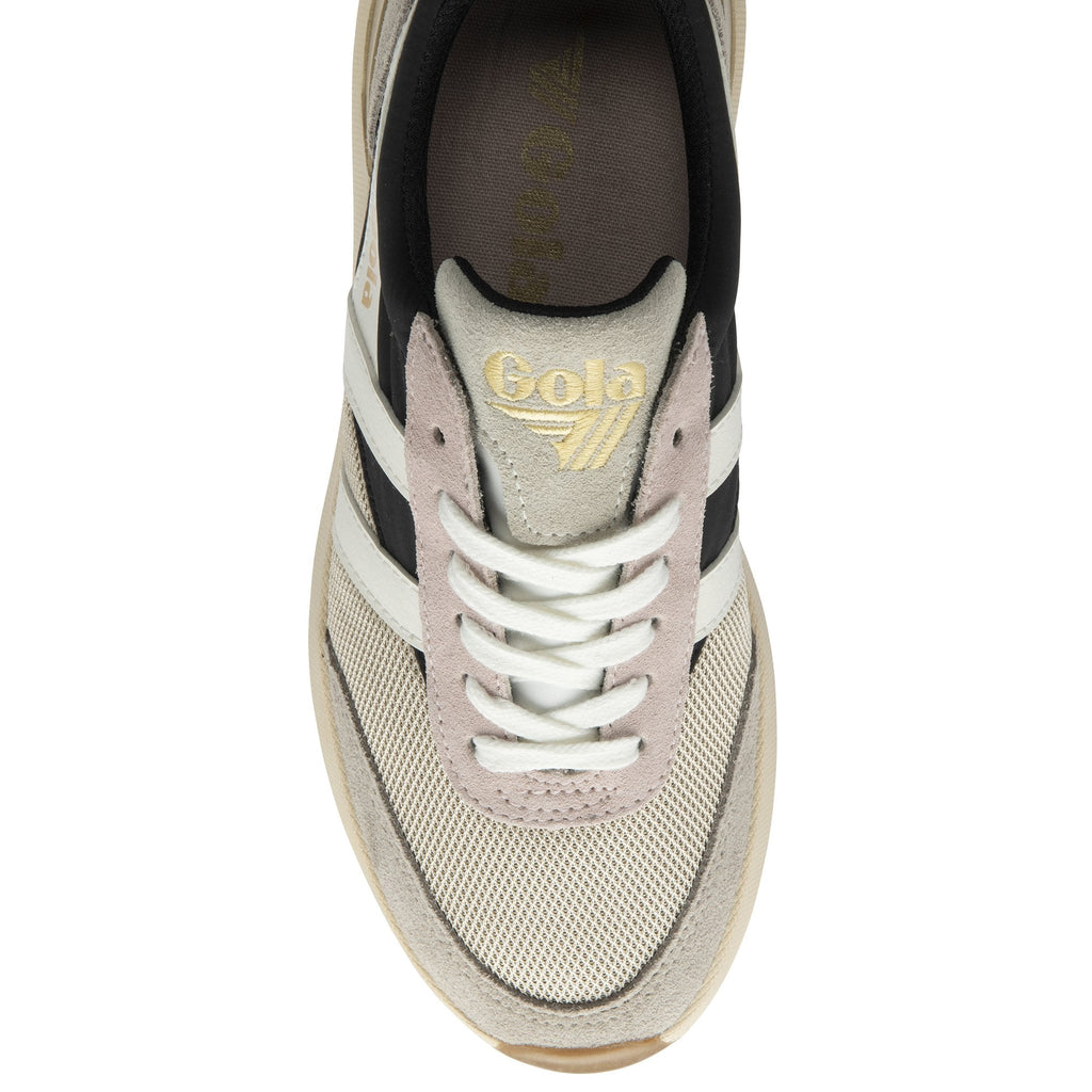 Top view of a casual women's sneaker with black, white, and gold accents.