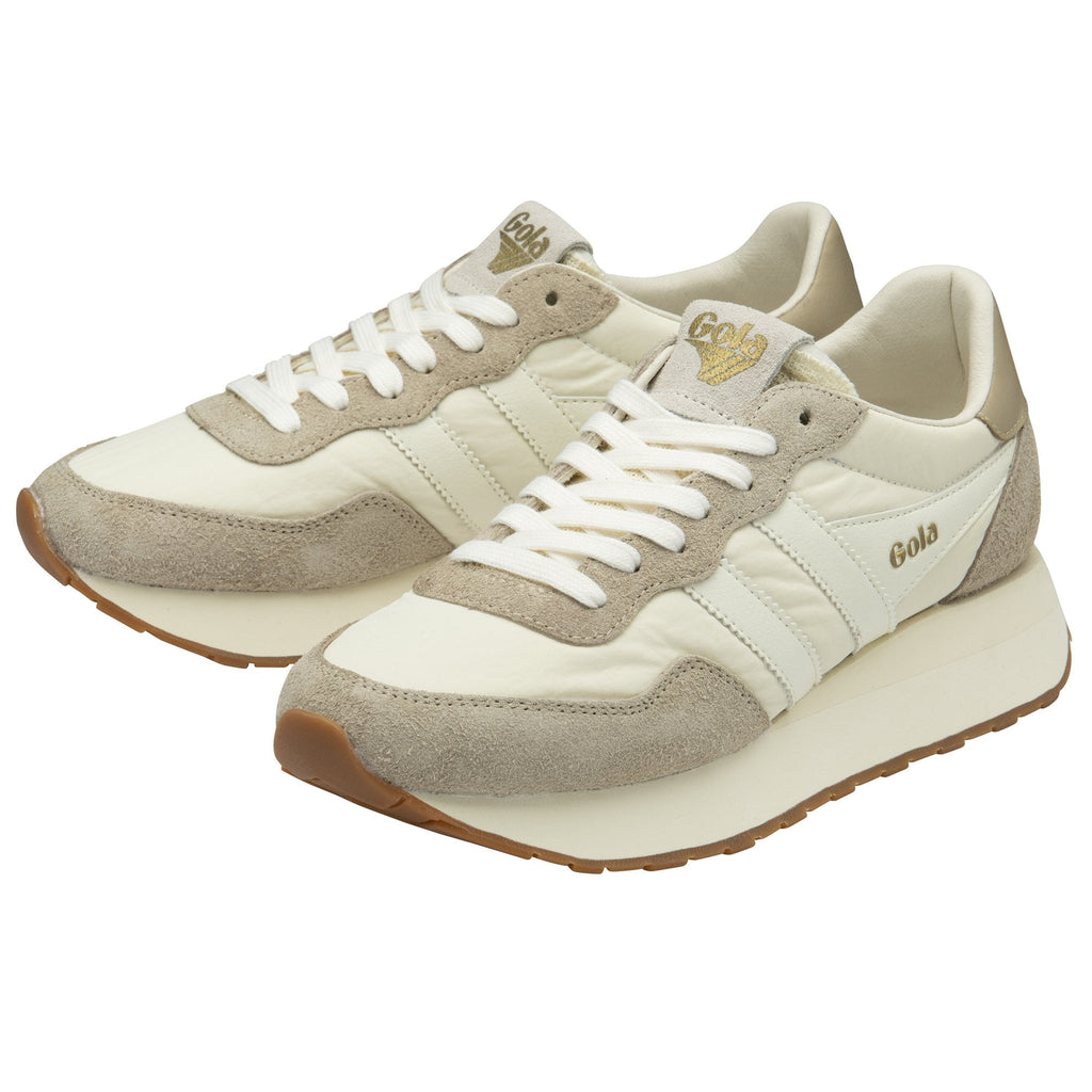 Angled view of a pair of white Gola women's trainers with suede detailing.