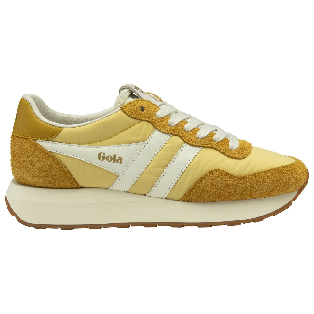 Side profile of a Gola shoe with a thick white sole, white stripes, and mustard yellow accents.