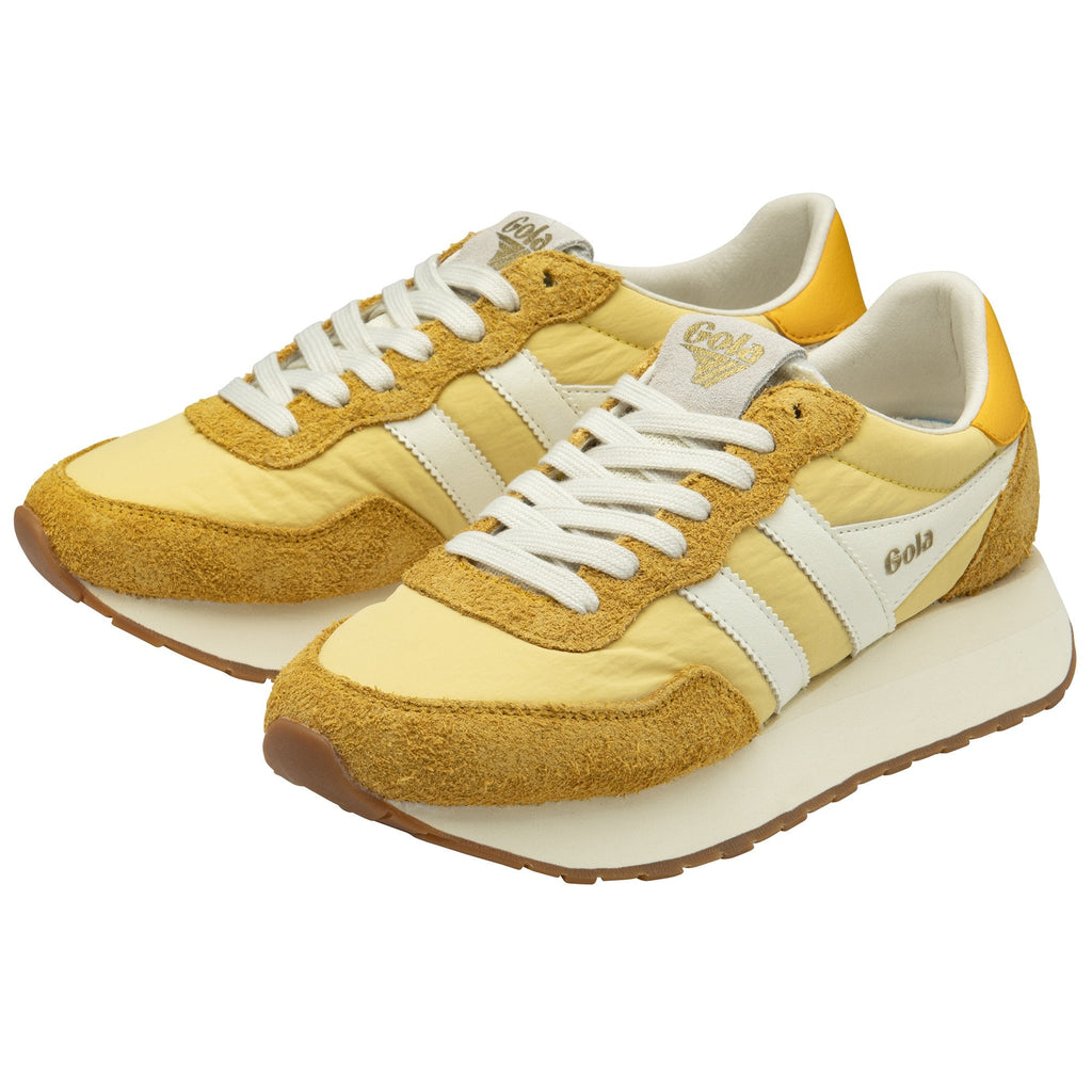 Two Gola shoes with thick white soles, white stripes, and mustard yellow accents.