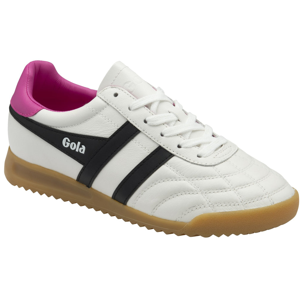 Angled view of a Gola men's indoor trainer with black stripes on a white base and a pink accent.