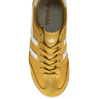 The top-down view of a single mustard yellow Gola trainer with white stripes.