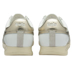 Back view of a pair of white and gold Gola sneakers.