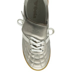 Top-down view of a silver Gola sneaker with white laces and a gum sole. 