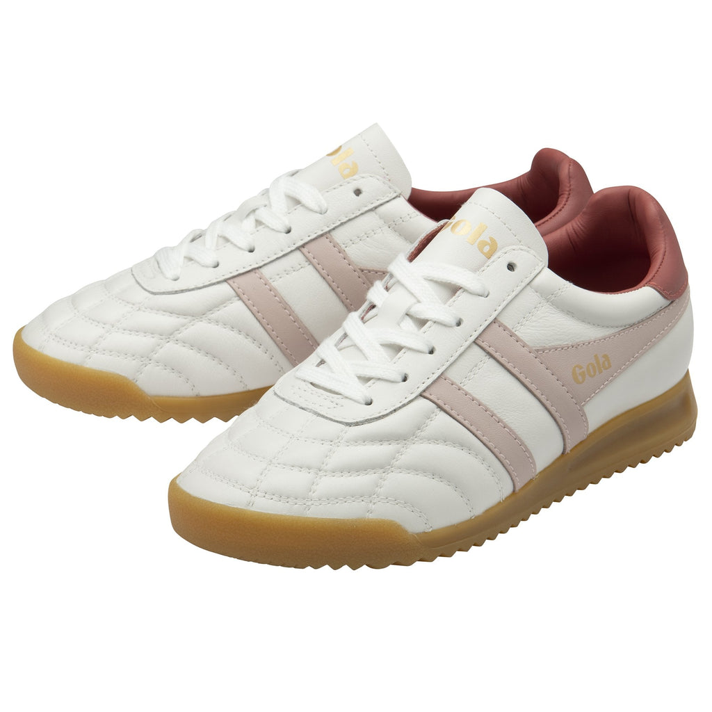 A pair of white Gola women's sneakers with pink stripes and gum soles, viewed from an angle.