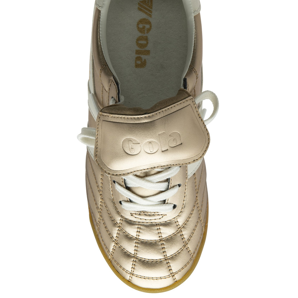 Top-down view of a golden Gola trainer, showcasing the laces and brand logo.