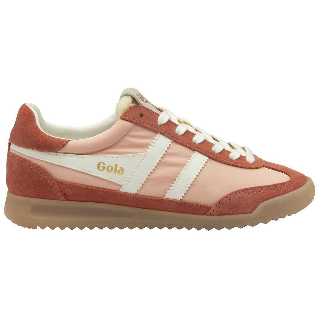 A single Gola women's trainer, in peach and russet with white stripes and laces.