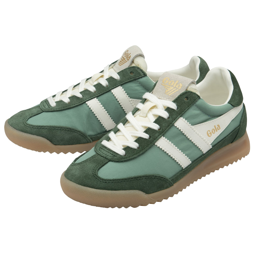 A pair of Gola Hurricane trainers in green and white, viewed from an angle.