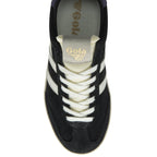 Top-down view of a black Gola trainer with white stripes and cream laces.