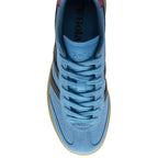 Top-down view of a light blue Gola sneaker with black stripes and blue laces.