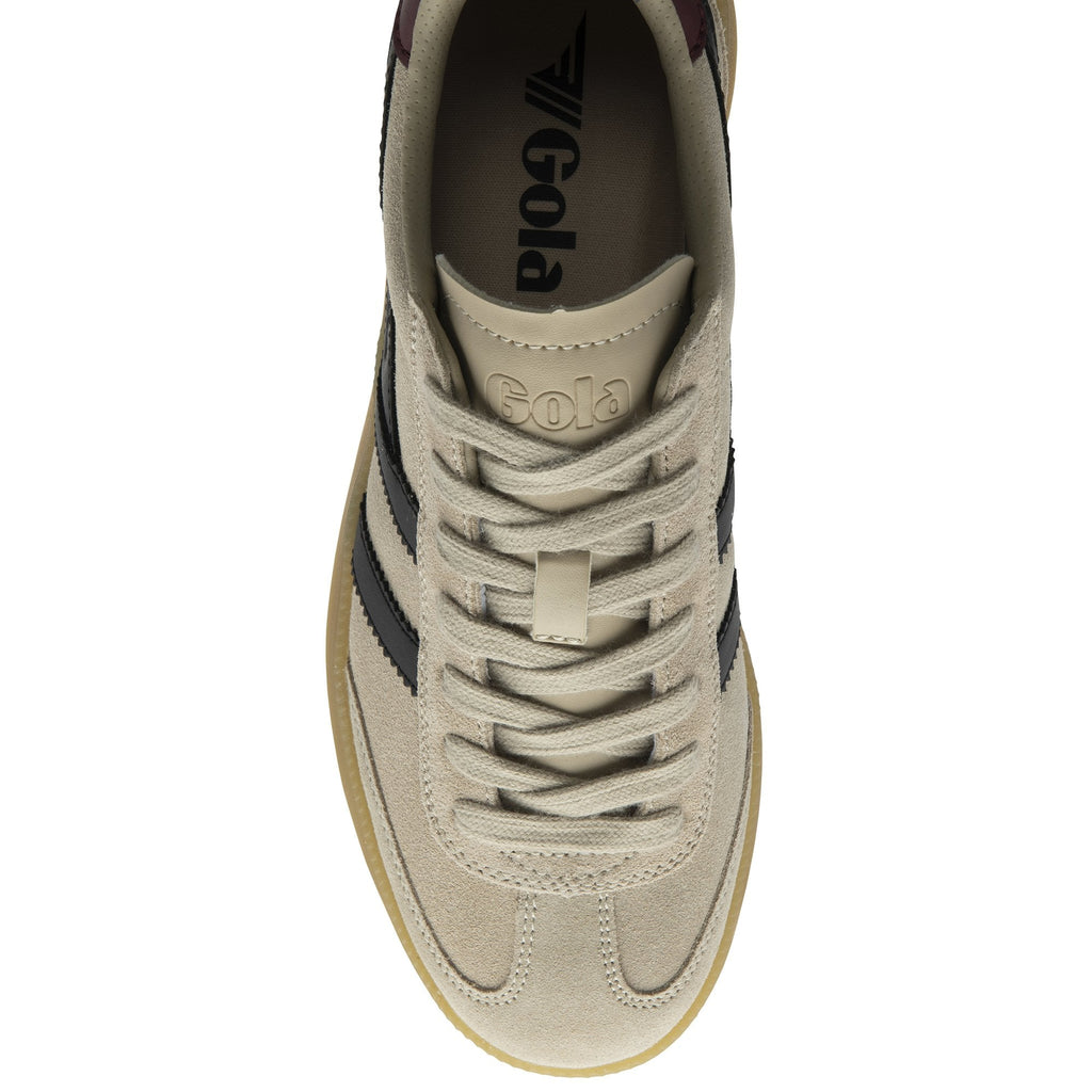 Top-down view of a single beige Gola sneaker with black stripes and laces.