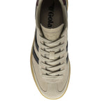 Top-down view of a single beige Gola sneaker with black stripes and laces.