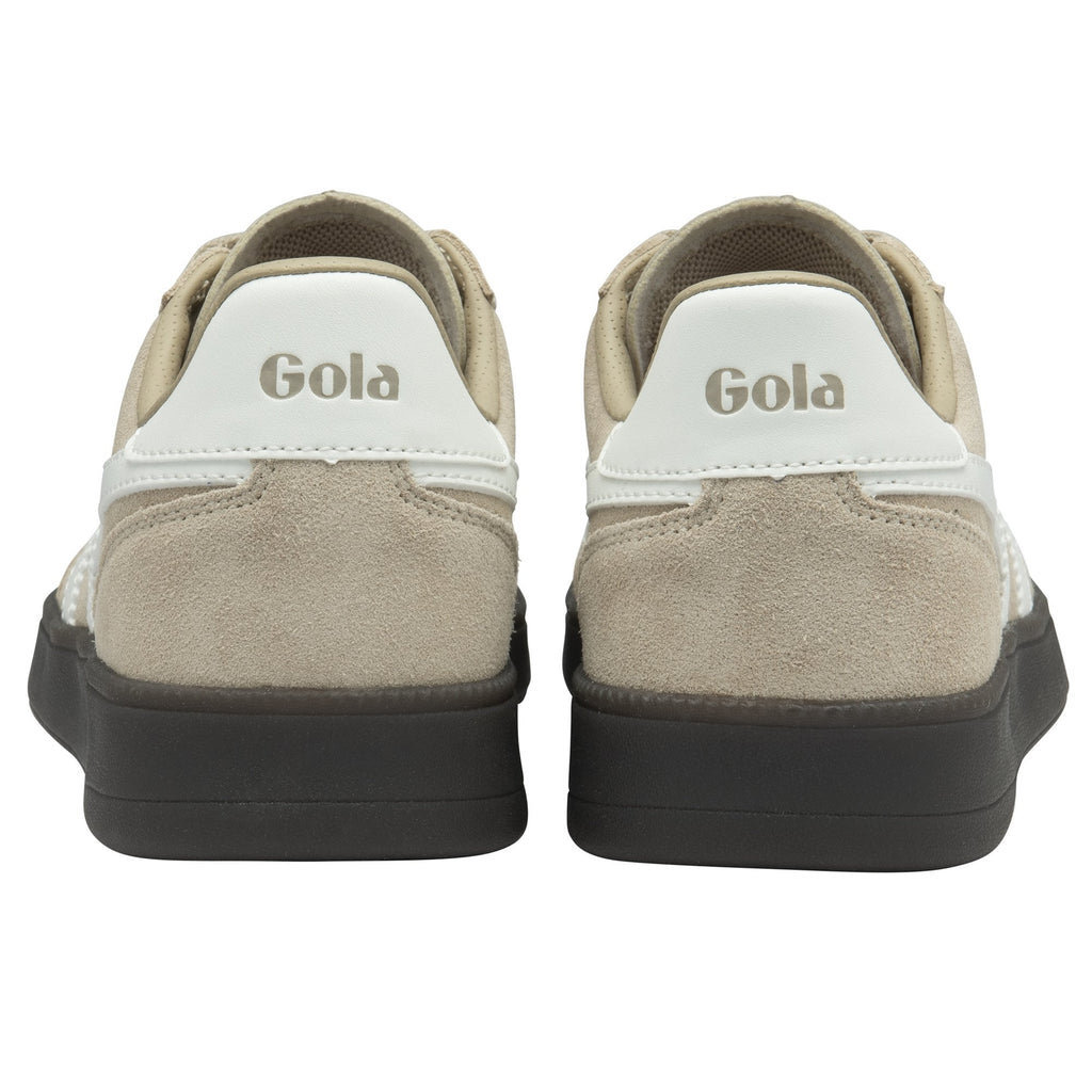The back view of two beige Gola sneakers, highlighting the white heel tab with logo.