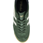Top down view of a dark green Gola Harrier sneaker with white stripes and laces.
