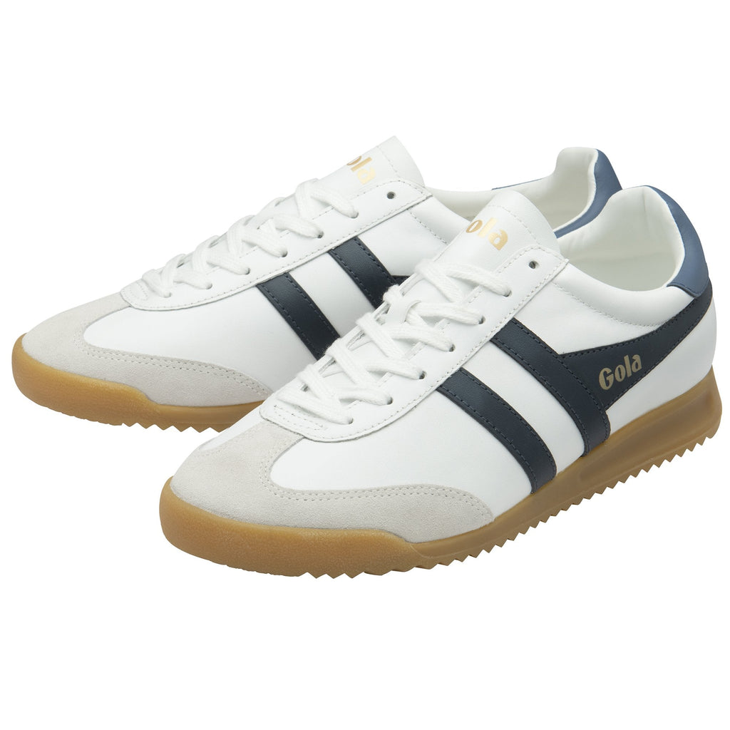 A pair of white and navy Gola sneakers with gum soles shown from the side.