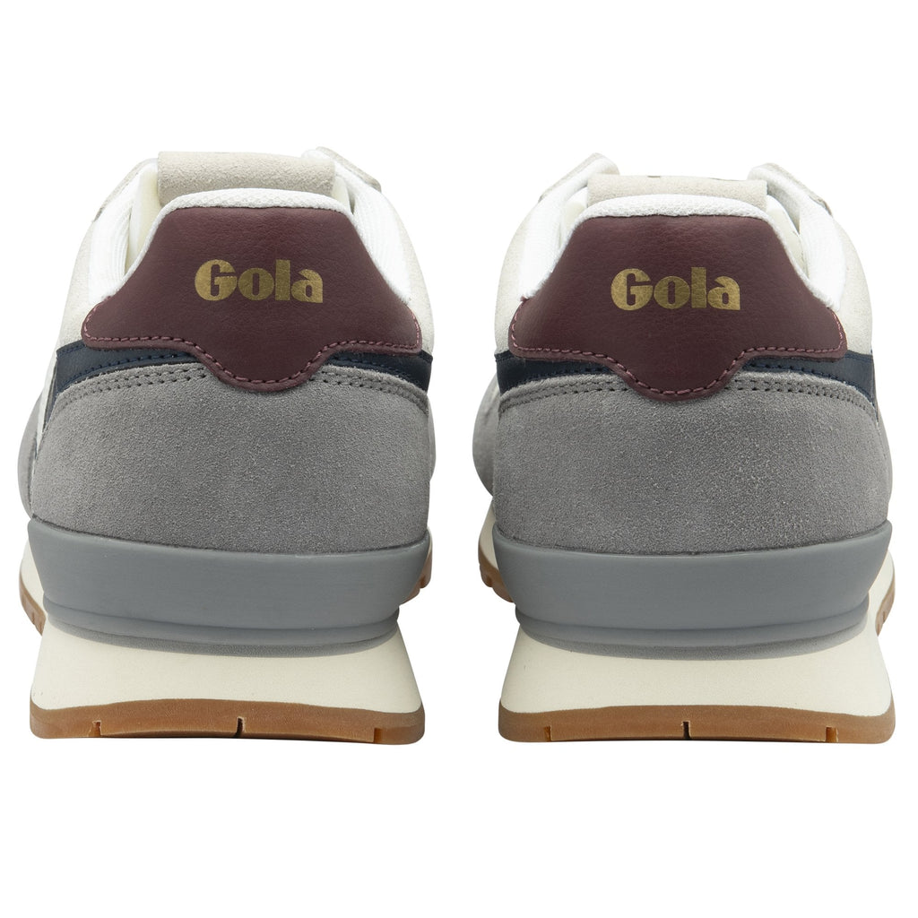 The back view of a pair of Gola men's trainers in white, grey, and navy.