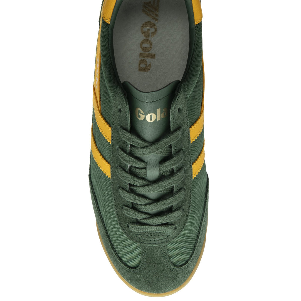 The top-down view of a green Gola trainer with yellow stripes.