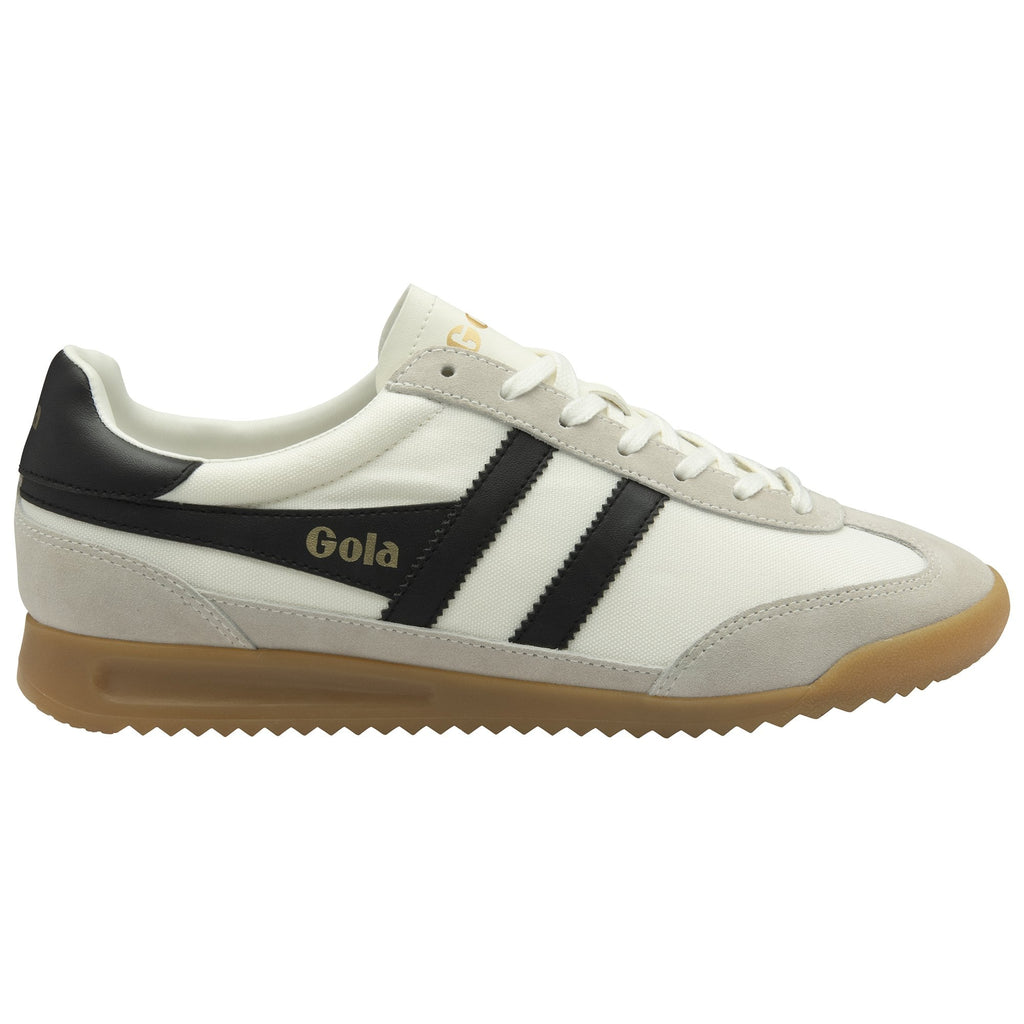 A white Gola Harrier Trainer with black stripes and a gum sole, viewed from the side.