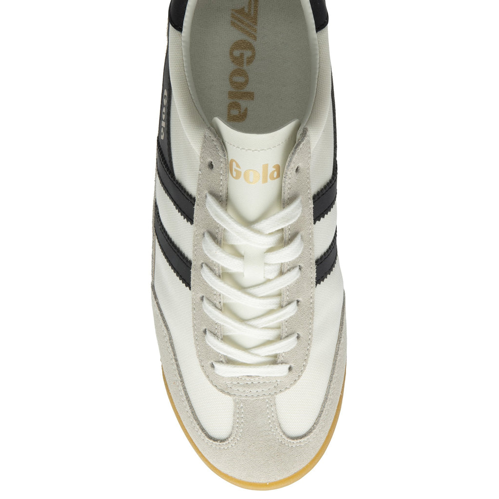 The top-down view of a white Gola Harrier Trainer with black stripes and white laces.