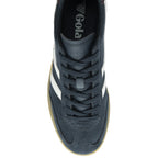 Top down view of a men's Gola sneaker, navy blue with white stripes and brown sole.