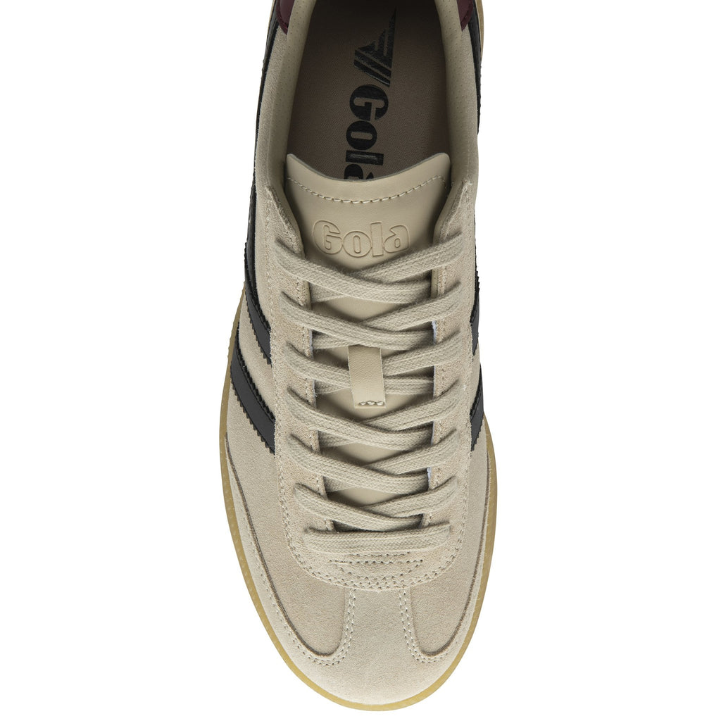 Top down view of a beige Gola sneaker with black stripes and a dark red heel accent.