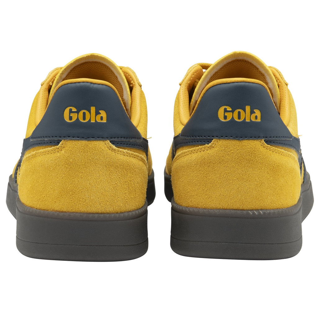 Back view of two mustard yellow Gola sneakers, showing dark blue heel detail.