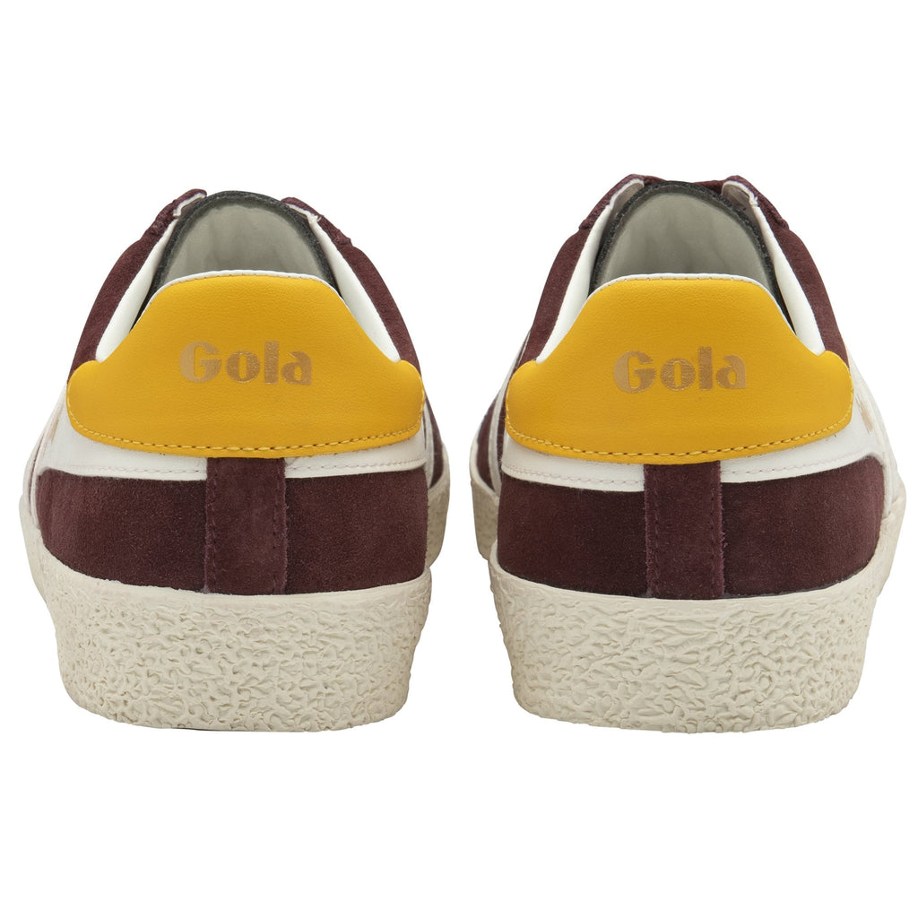 Rear view of two Gola Harrier trainers in maroon suede with yellow heels.