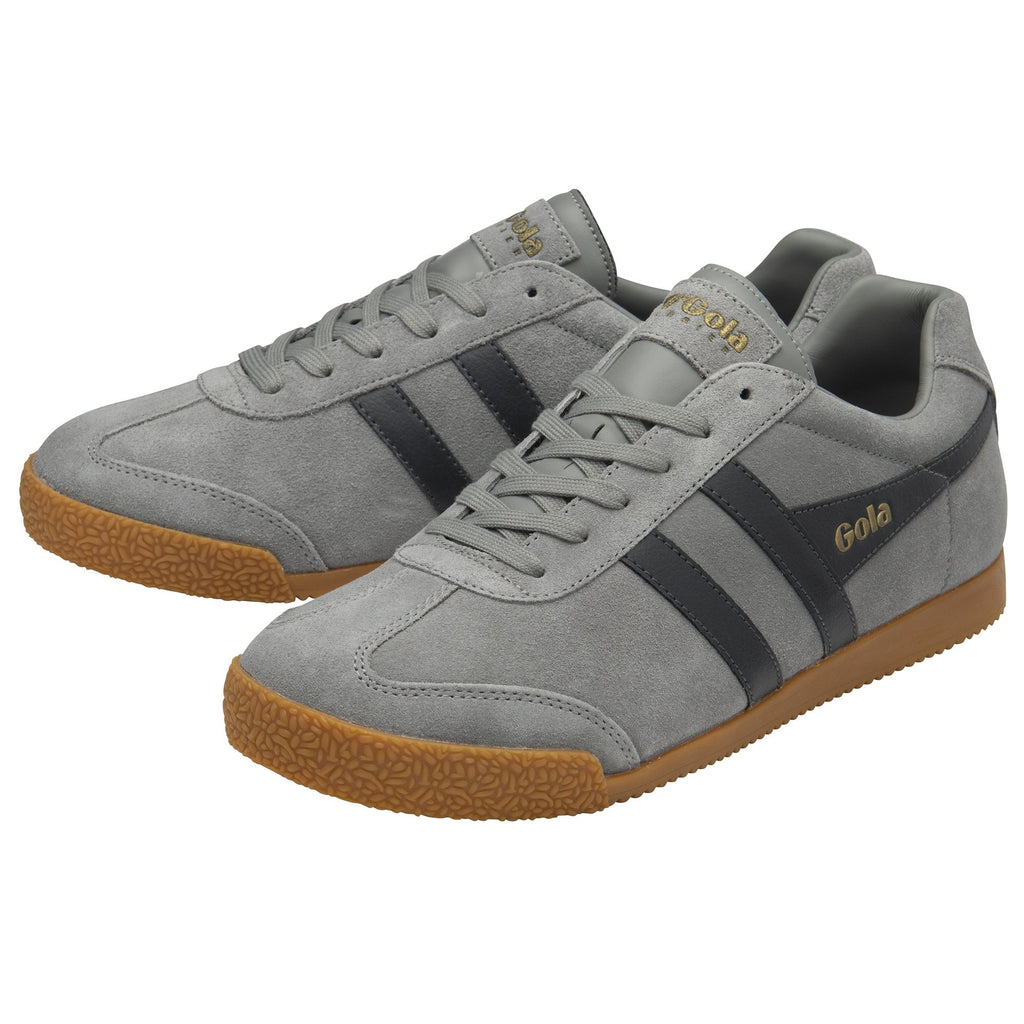A pair of gray Gola sneakers with dark gray stripes and brown soles, viewed at an angle.