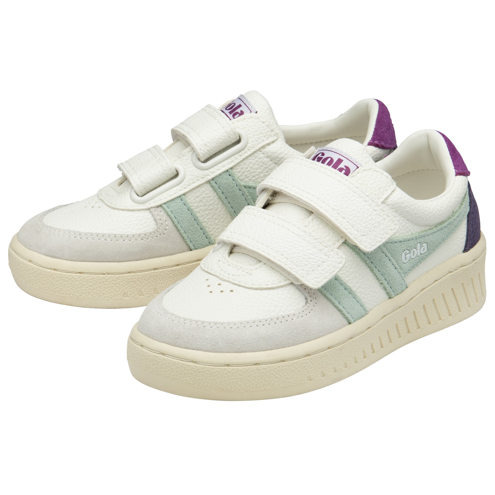 Two white Gola children's trainers, with two hook and loop straps and green and purple accents. 