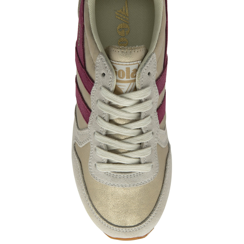 A single Gola women's trainer, in cream, tan and purple, shown from above.