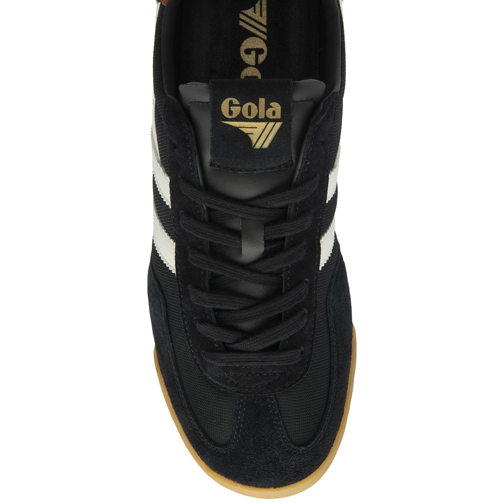 A top-down view of a black Gola trainer with white stripes and a gold logo on the tongue.