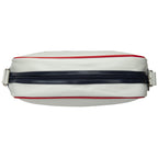 White Gola messenger bag with navy stripe and red piping, top view.