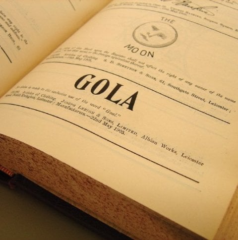Close-up of an open book showing the word "GOLA" in large print and other text.