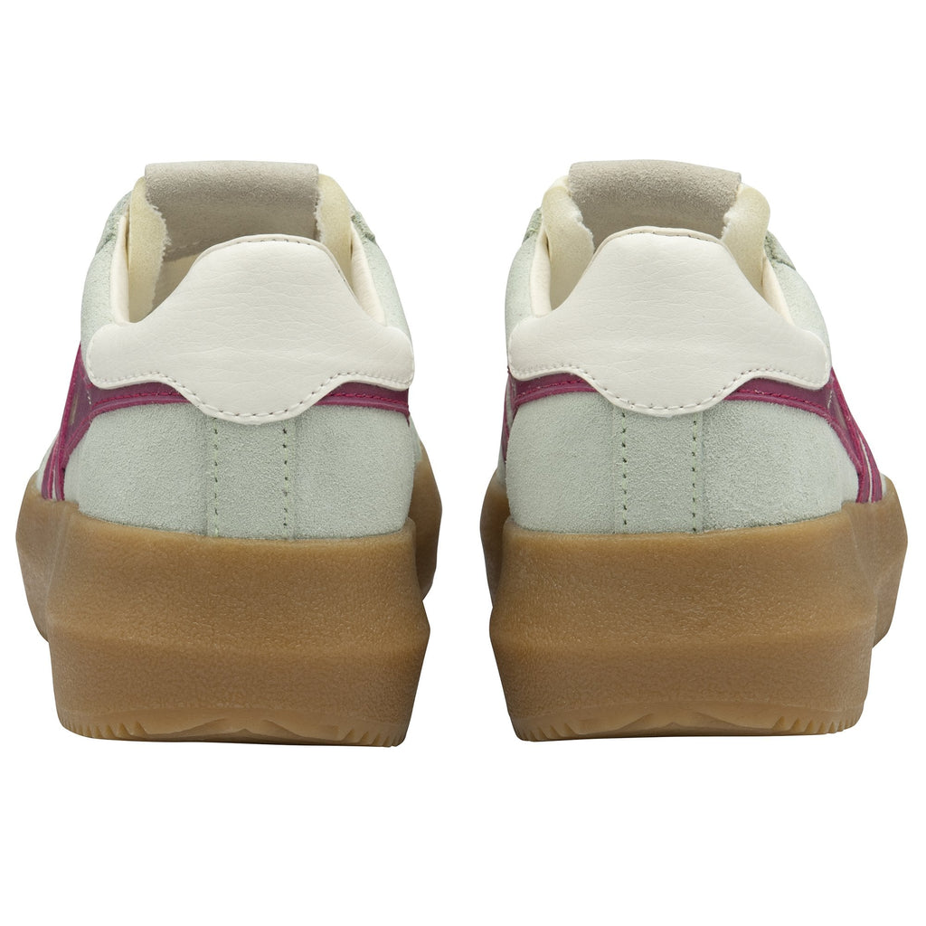 The back view of a pair of Gola sneakers, light gray with magenta accents and brown soles.