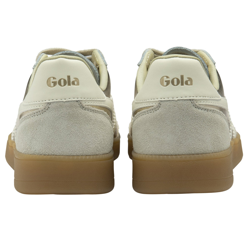 The back of a pair of Gola sneakers, showing the Gola logo on the heel.