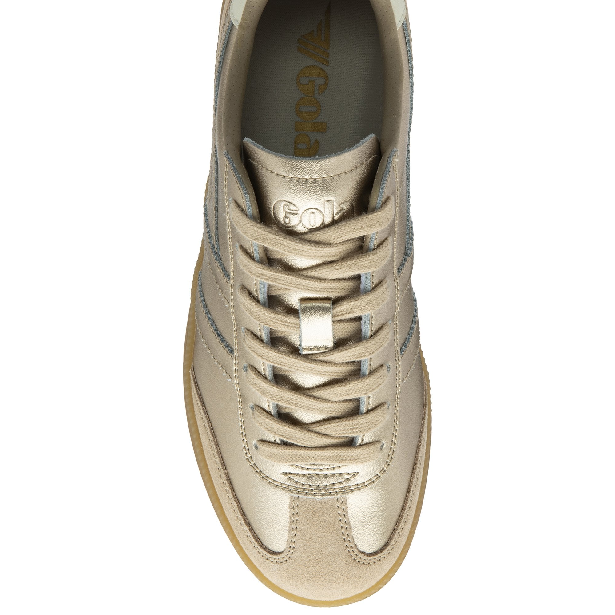 An overhead view of a single gold and tan sneaker with a gum sole.
