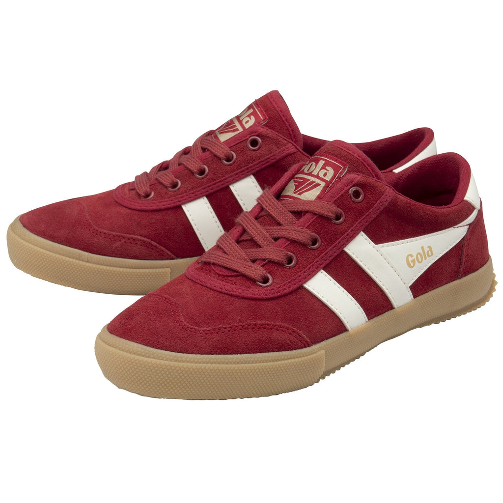 A pair of Gola low-top sneakers in red suede with white stripes and brown soles.