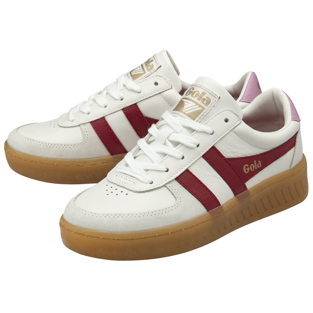 Pair of white and red Gola sneakers with gum soles and pink heel tabs positioned at an angle.