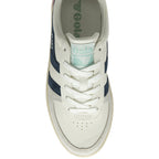 Top down view of a white Gola trainer with navy stripes.