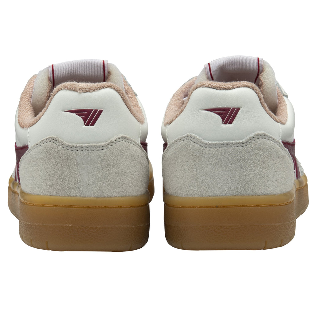 The back view of a pair of white Gola sneakers with burgundy heel accents and gum soles.