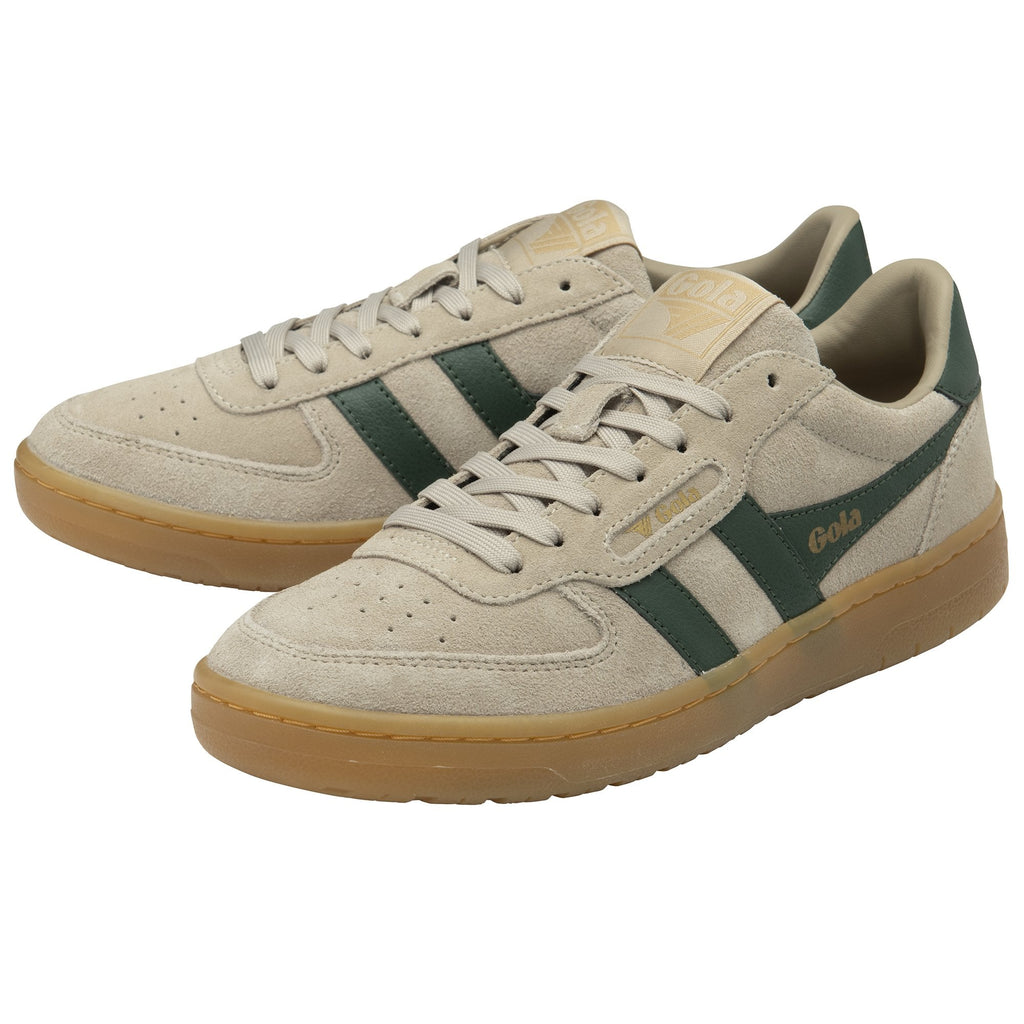 A pair of Gola low-top sneakers in beige suede with green stripes and gum soles.